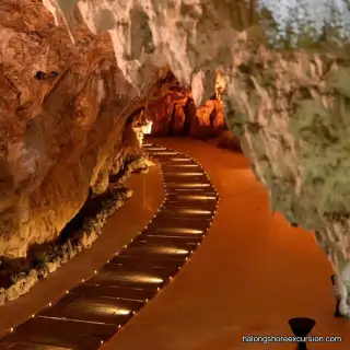 Illuminated walkway inside Dragon Pearl Cave